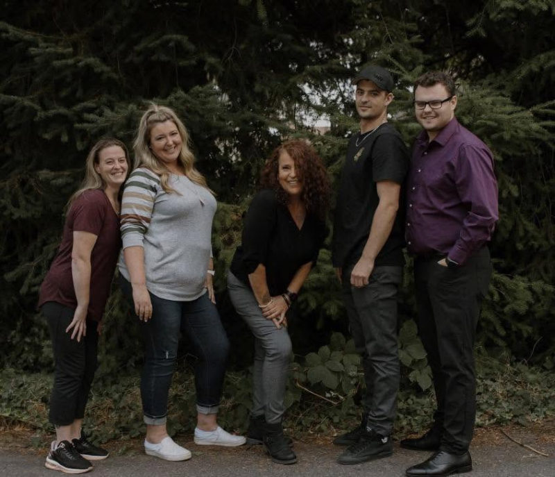 Five of Tali's family members posing together.